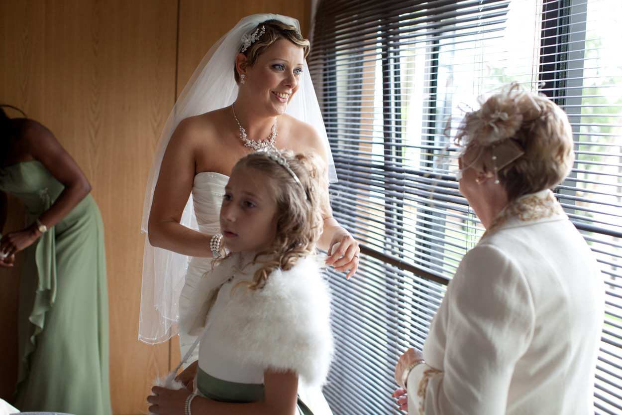 Bride smiling warmly at her mum as they chat during prep.