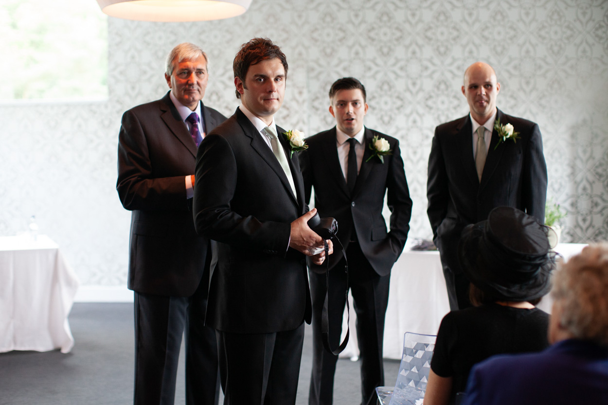 Groom and groomsmen gathered inside the ceremony room at the KP Club.