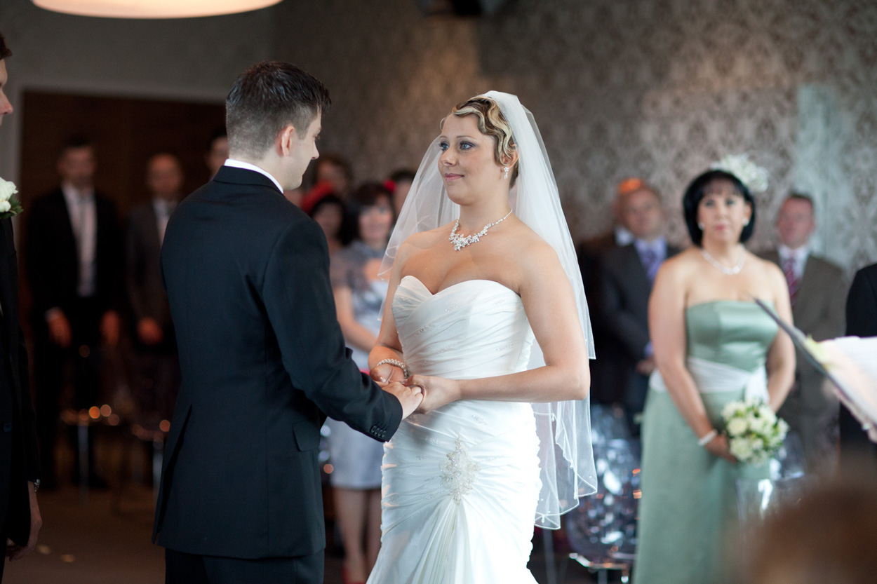 Close-up of the couple’s hands as they exchange vows.