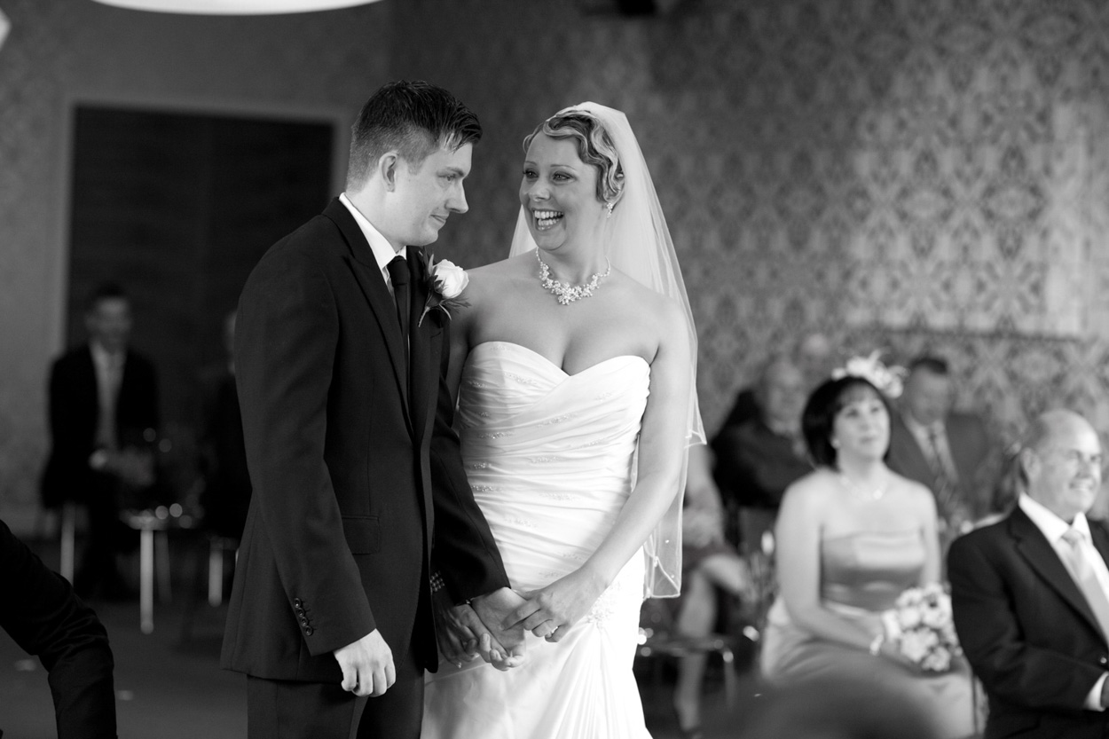 Sam looks across at her groom, full of happiness.