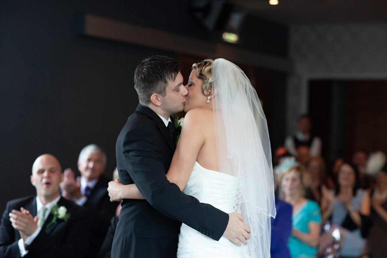 The couple walk together towards the register signing table.