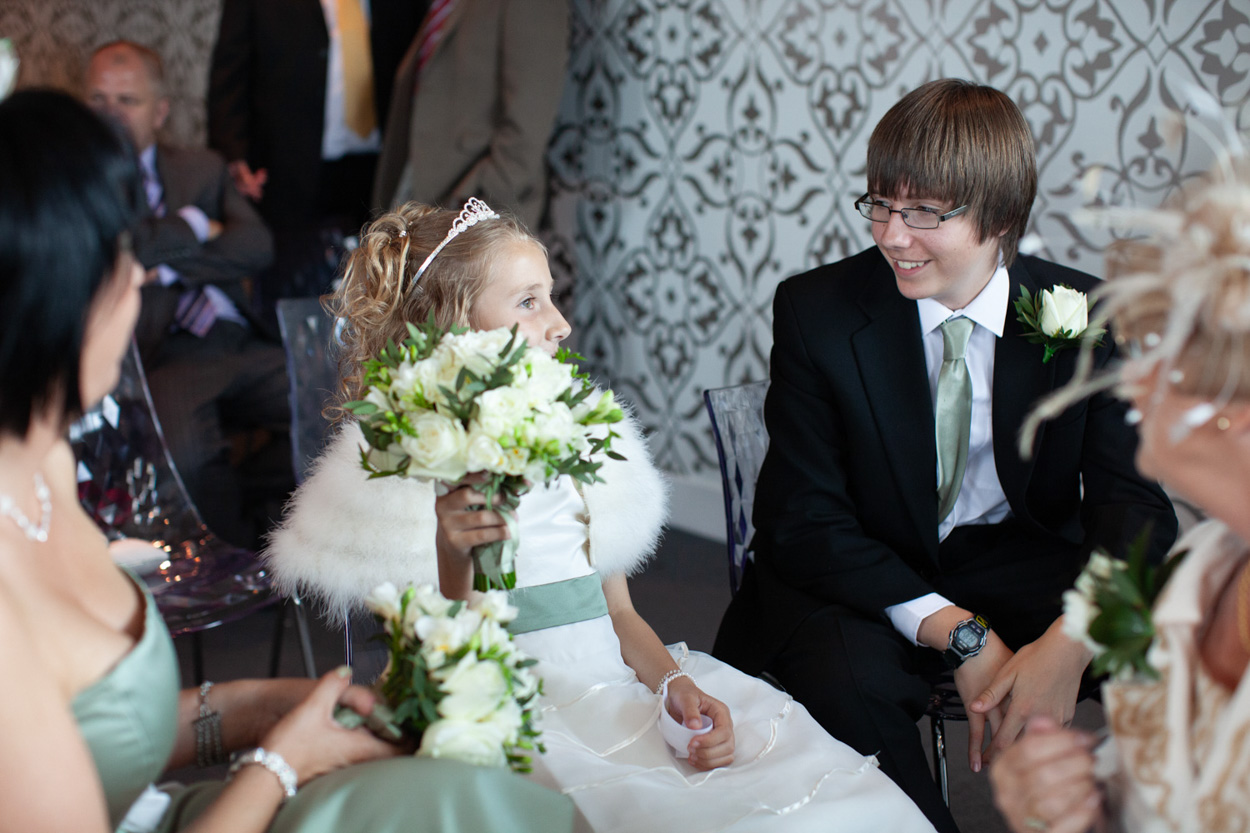 Sam hugs her father with a hand resting on her mother’s shoulder.