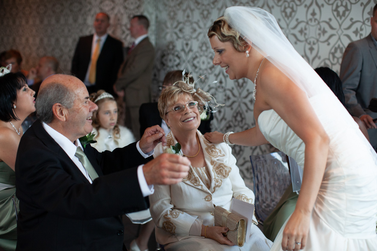 Sam pulls a playful face as she and Tim exit to confetti.