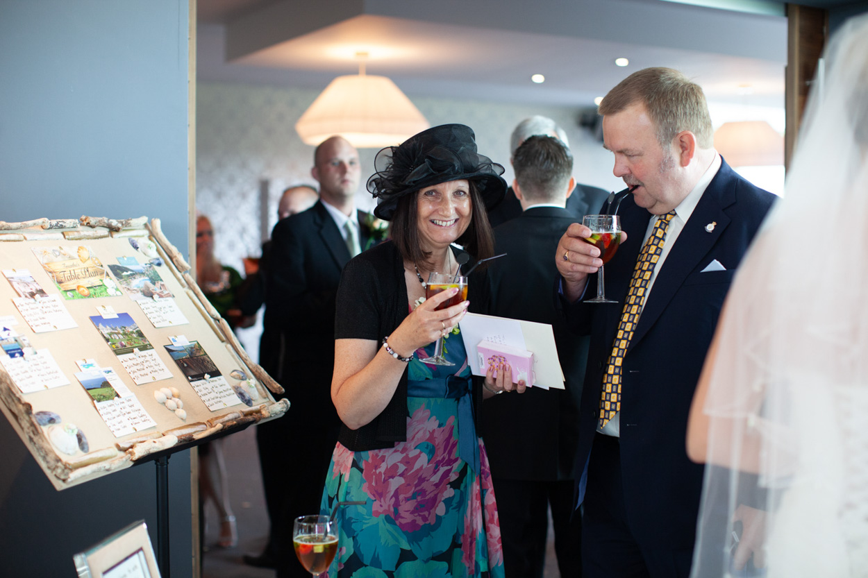Sam & Tim with four children including a baby in group photo by young trees.