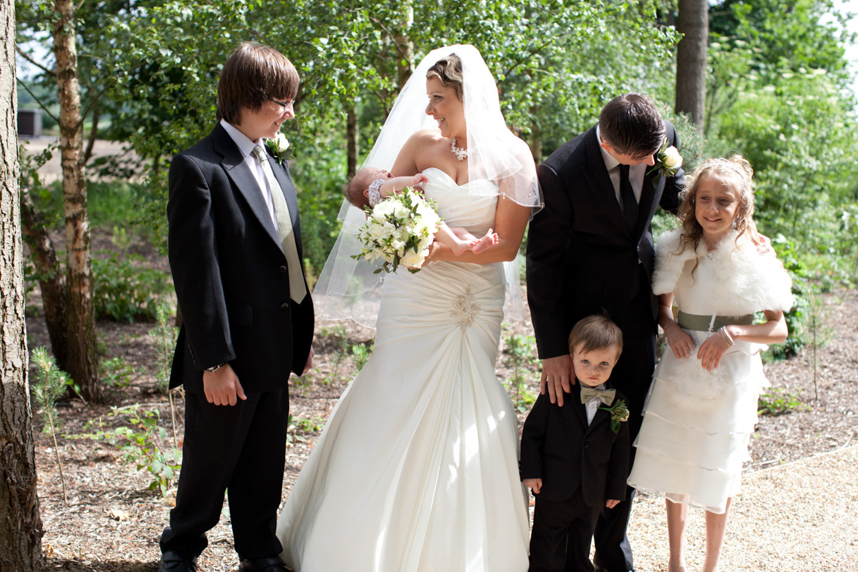 Sam & Tim pose with her parents under gentle sun.