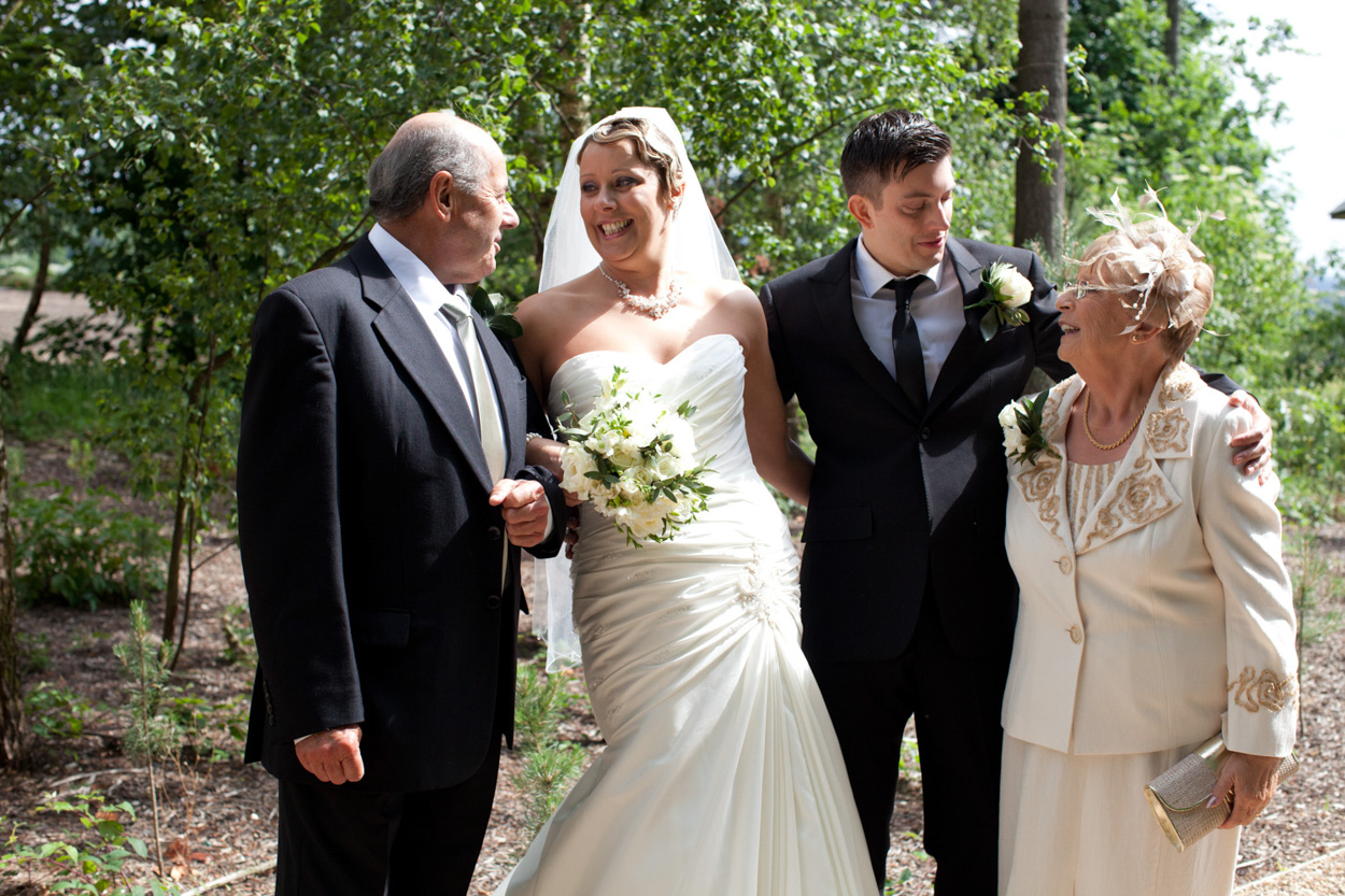 Sam & Tim with the three bridesmaids in bright sunshine.