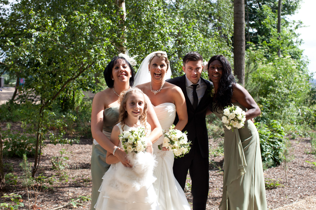 Couple sit by the venue’s waterside in B&W, sharing a natural moment.