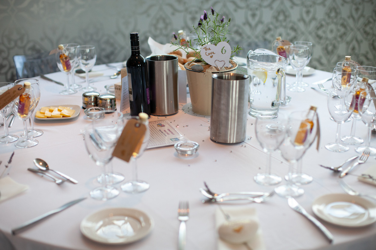 The groom’s black goblet with silver decoration on the table.