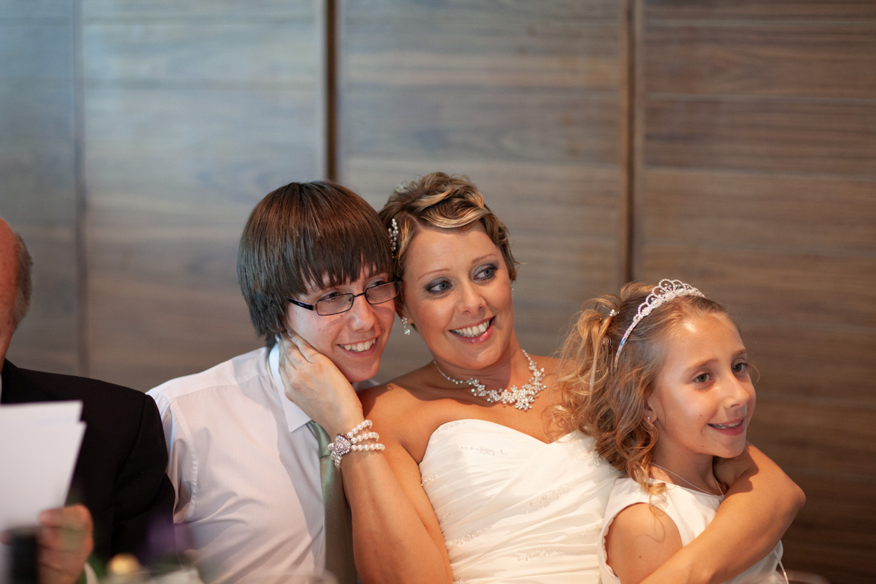 The group laughs together as they look at the photo just taken on the guest’s camera.