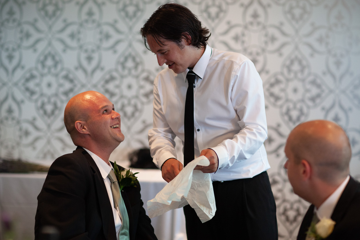 Sam and Tim smile as they cut into a rich chocolate cheesecake instead of a traditional cake.