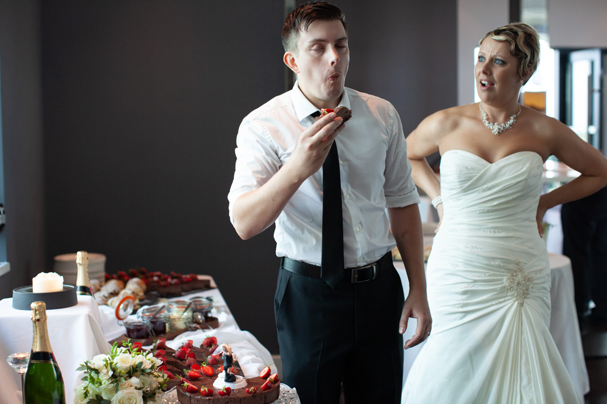 Tim eats more cake while Sam laughs at his enthusiasm.