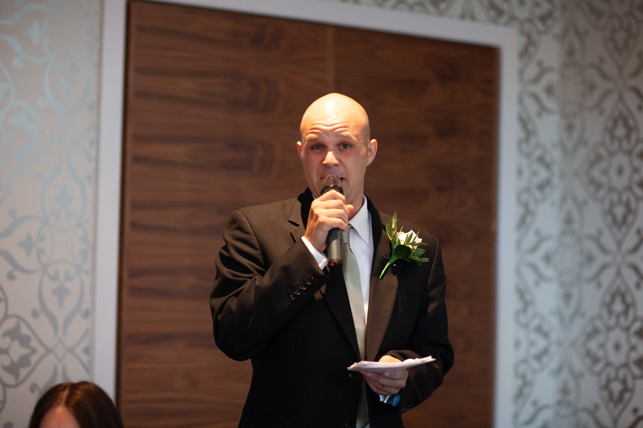 The second best man delivers his speech with full expression and dramatic flair.