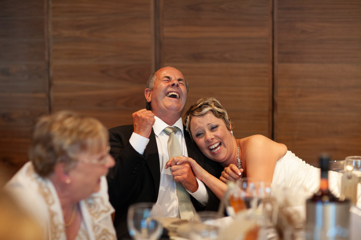 Tim drops his head into his hands, laughing through the embarrassment.