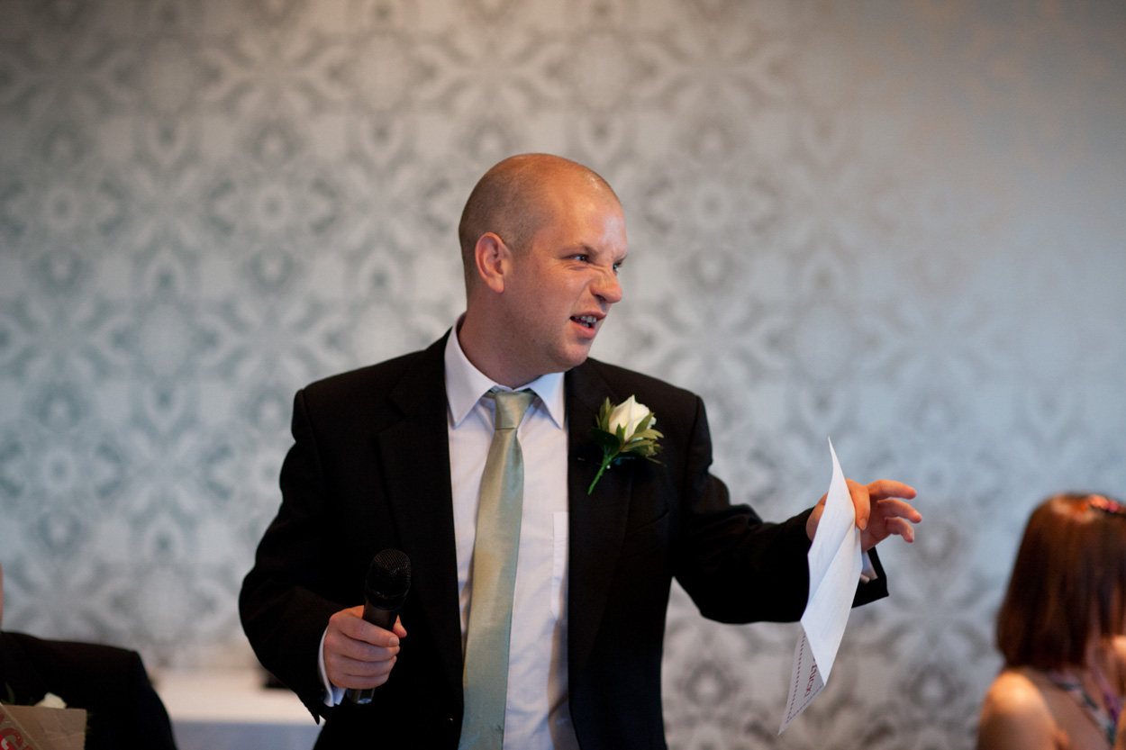 A guest reacts with joy as the speech timing winner is announced.