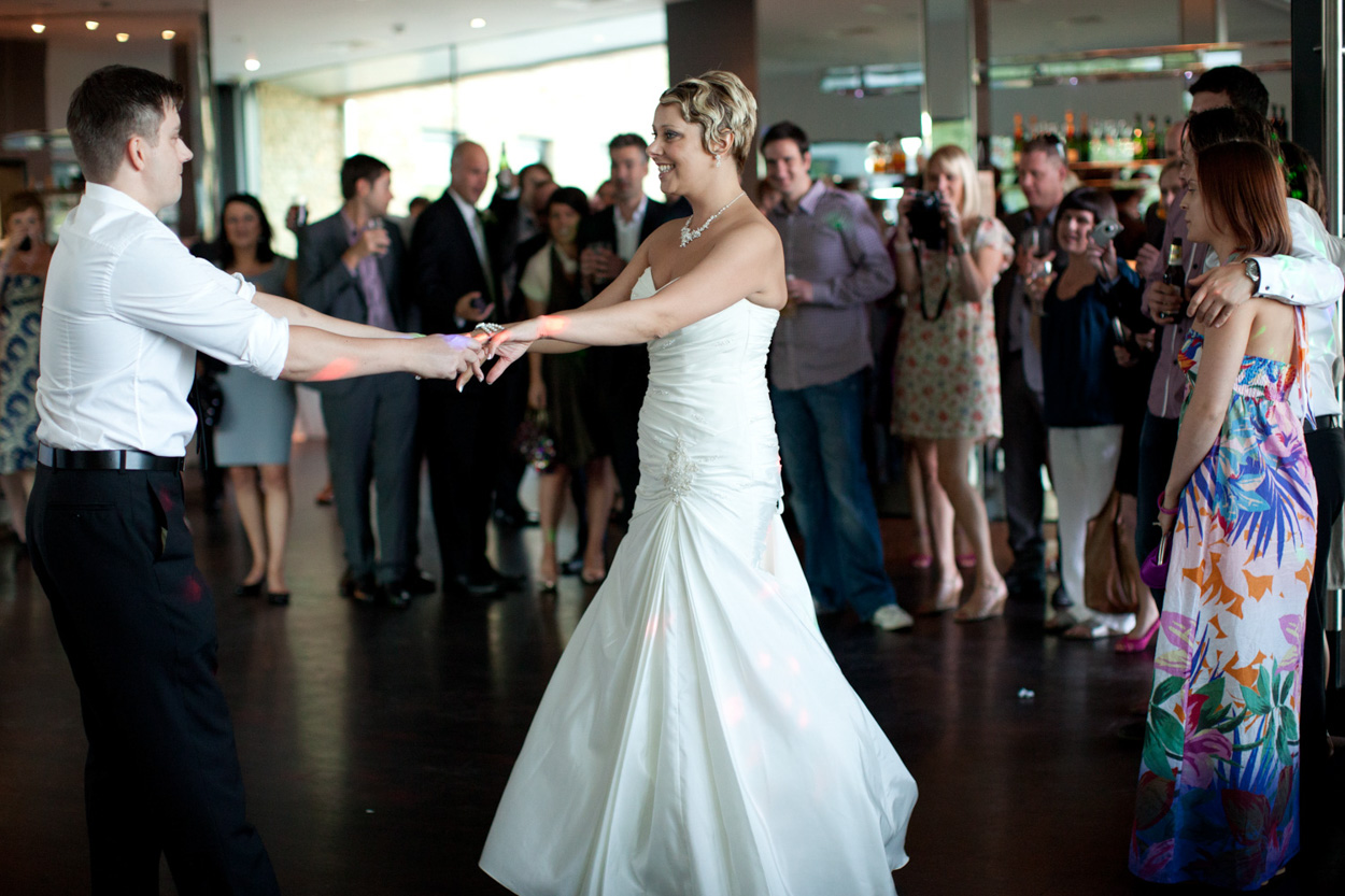 The couple shares a close hug while dancing, caught in a tender moment.