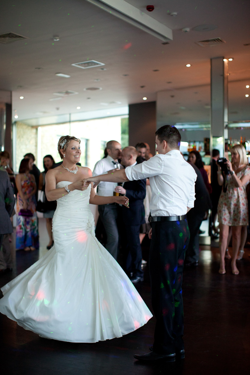 Sam smiles knowingly while dancing, holding a secret joy.