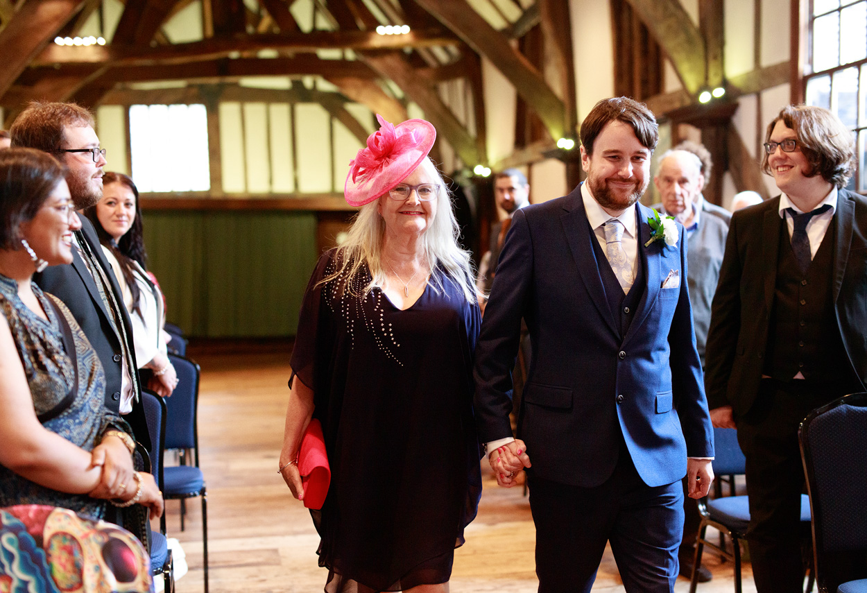 Groom and Mother walking down the aisle at Merchant Adventurers Hall
