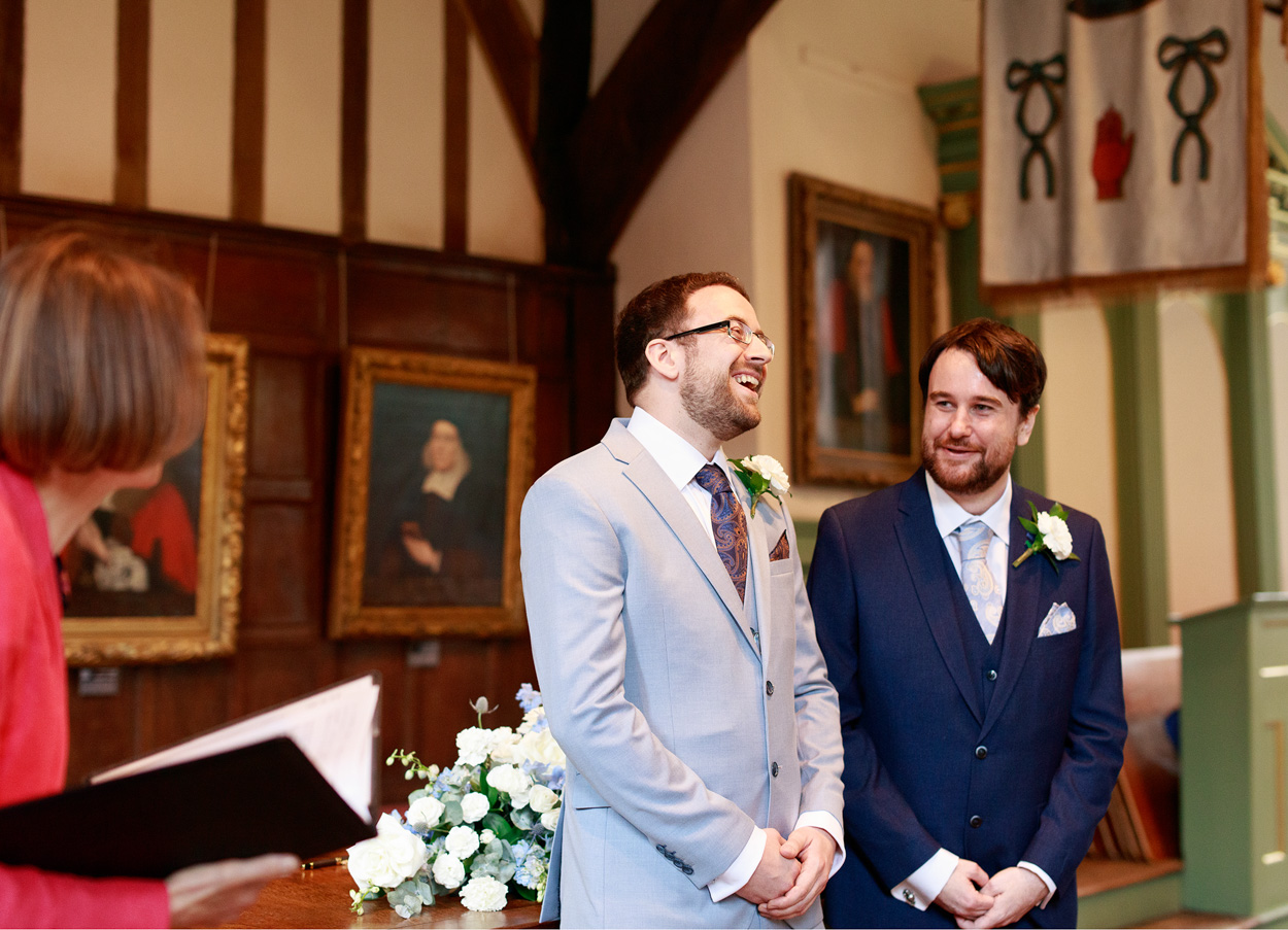 Grooms smile during the ceremony at Merchant Adventurers Hall in York