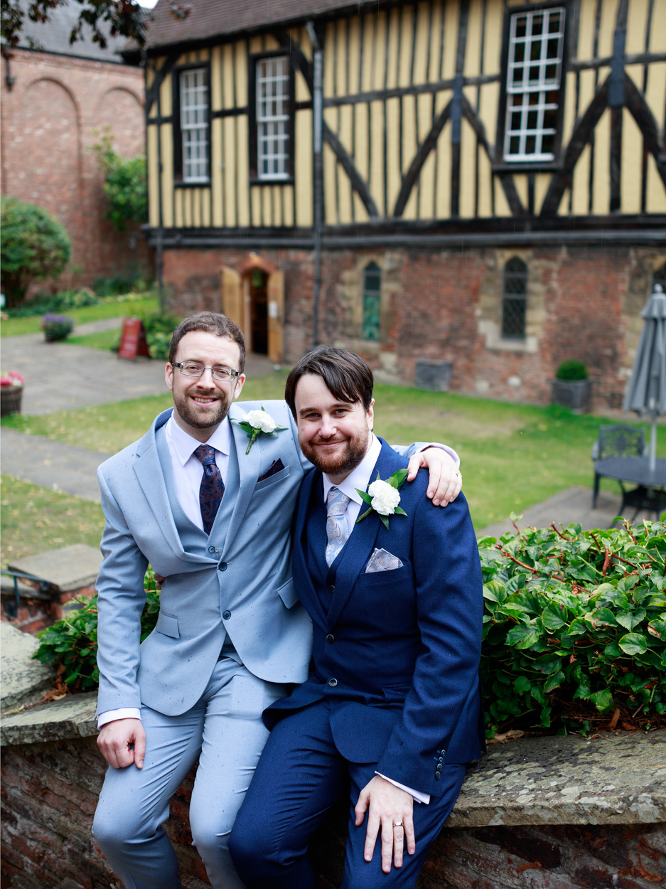 Couple portrait with Merchant adventurers Hall behind them as the rain returns