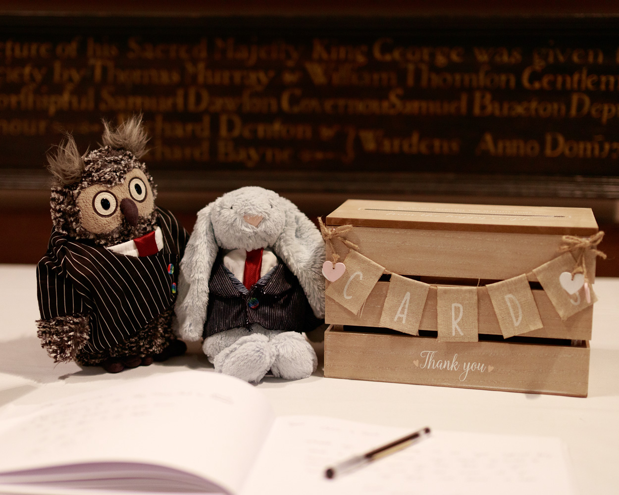 Card table with an owl and hedgehog soft toys of the boys