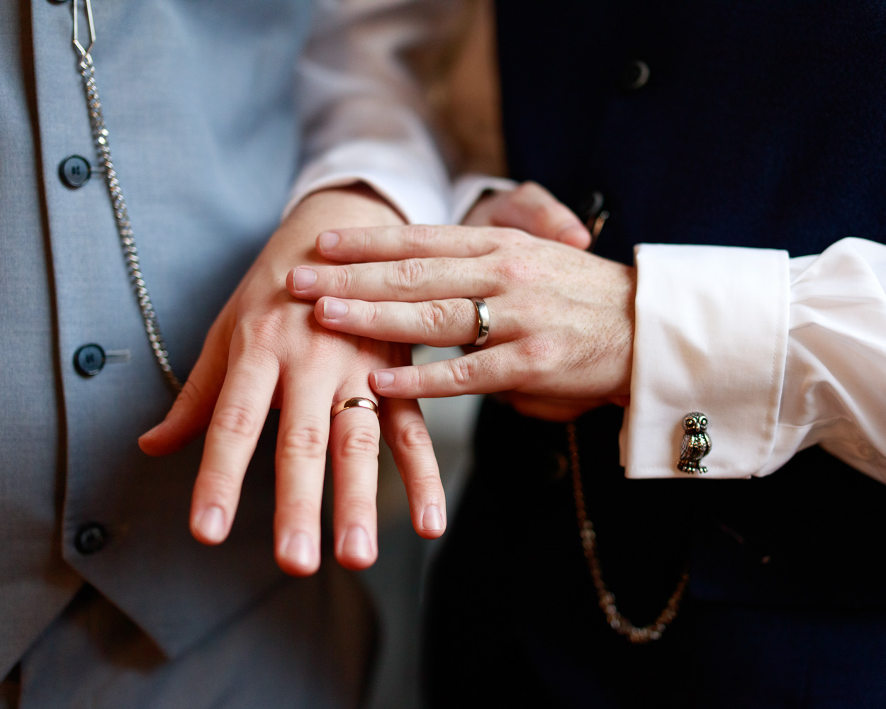 THe grooms pose showing the rings