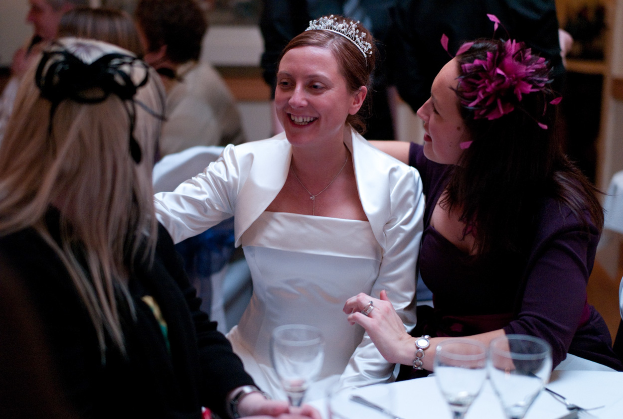 A smiling bride chats with guests