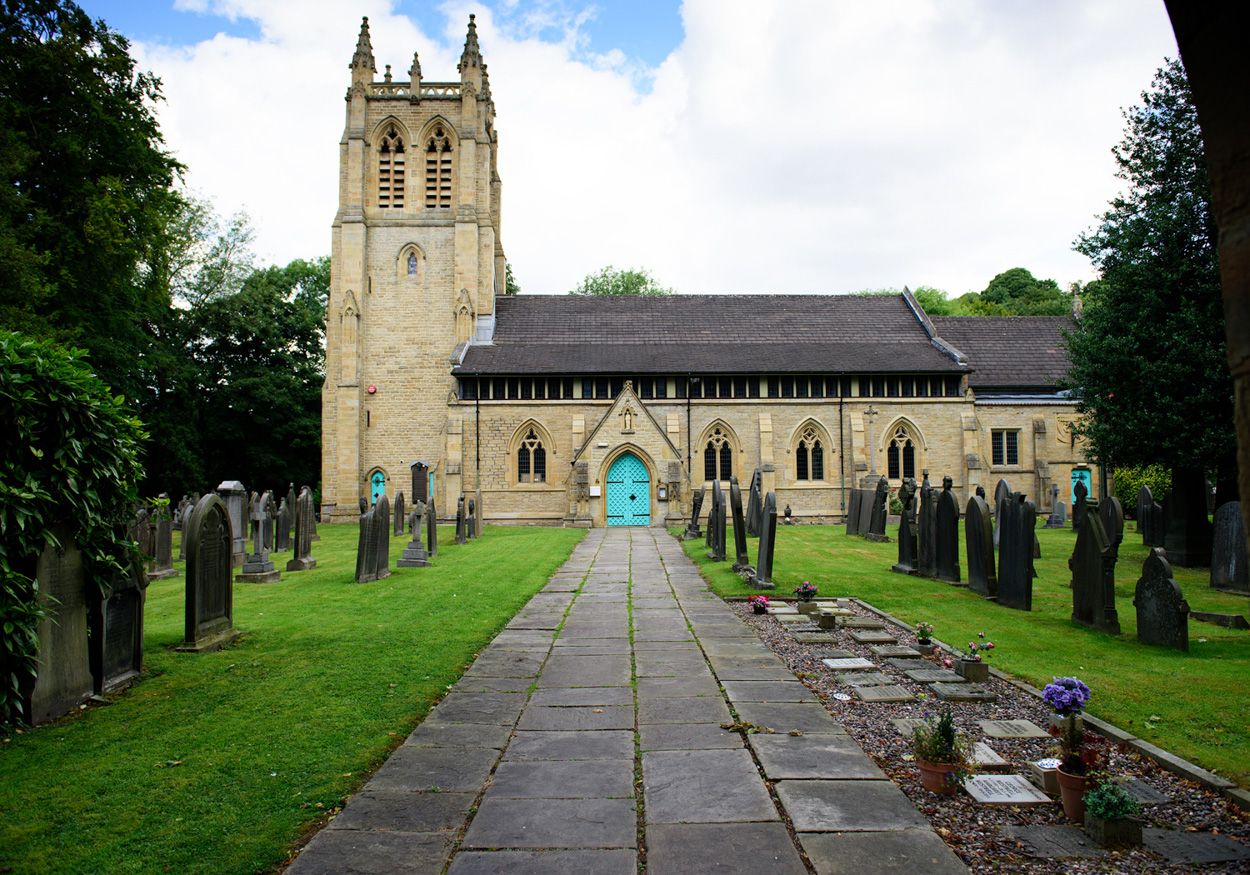St Paul’s Church in Armitage Bridge, West Yorkshire — pathway to the blue door under bright skies.