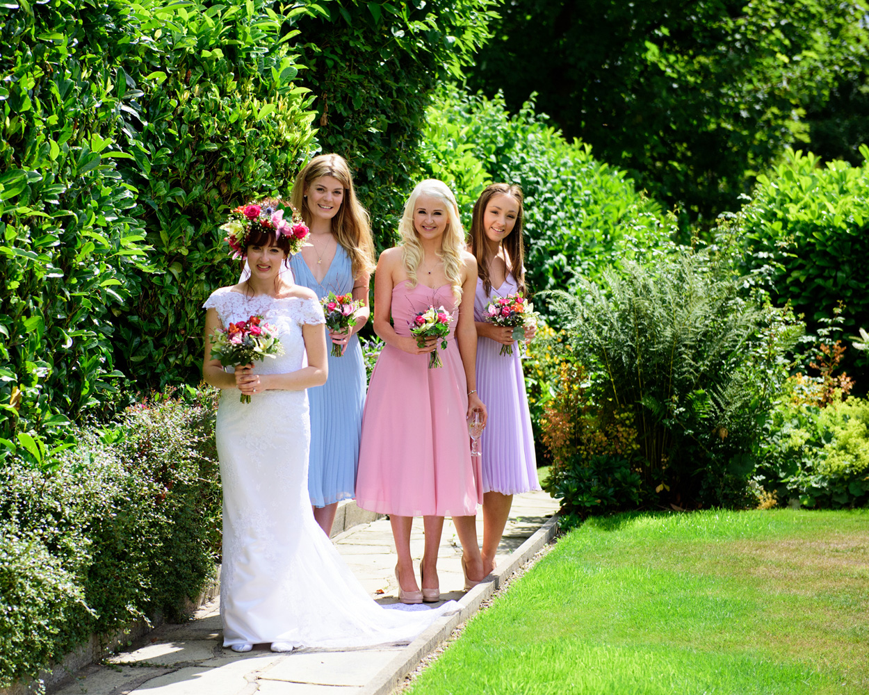 Close-up of bridal bouquet with purple ribbon detail — West Yorkshire wedding flowers.