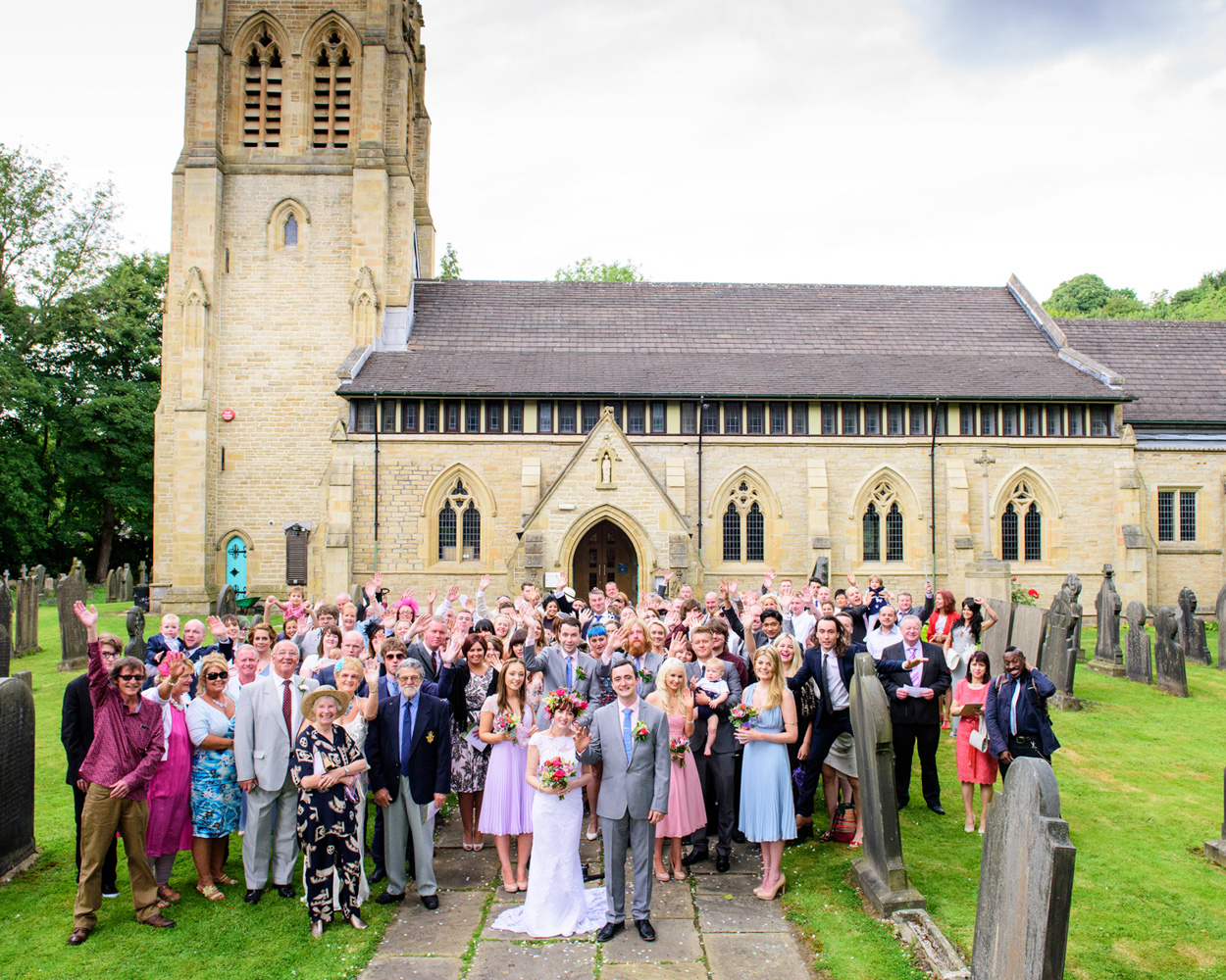 A couple dressed in party hat and deco mask smile in the photo frame at the West Yorkshire reception.