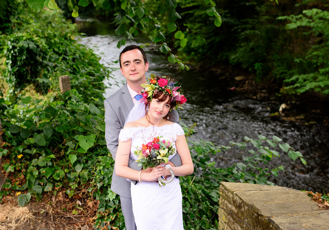 Sweet table filled with treats, kisses sign, and pastel decor inside the tent.
