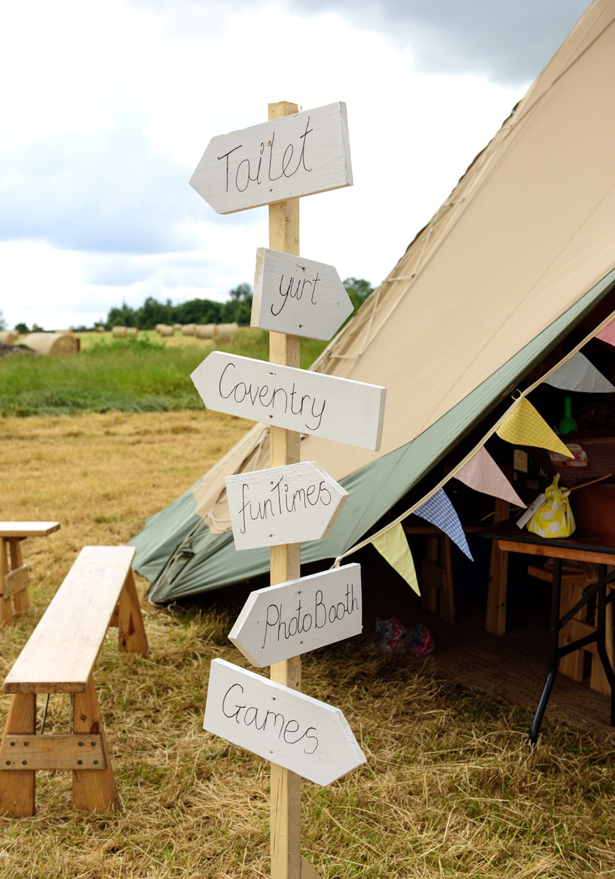 More wedding guests laugh together inside the West Yorkshire reception tent.