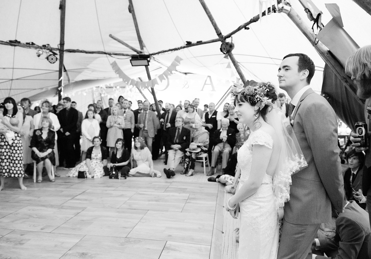 Bride Chloe stands in an ice cream van handing John a 99 Flake with sunshine behind.