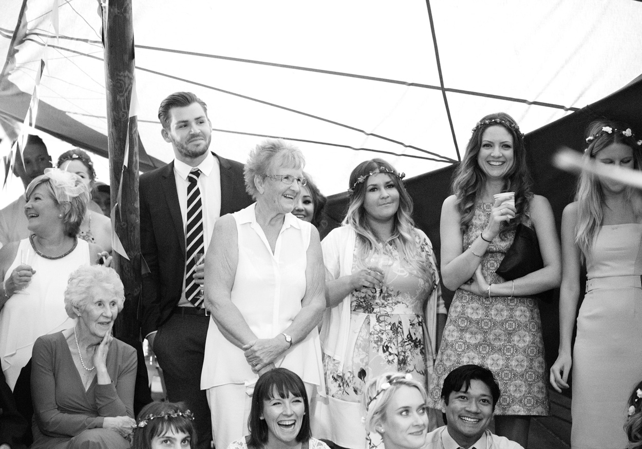 The couple smile, holding hands while ceilidh dancing.