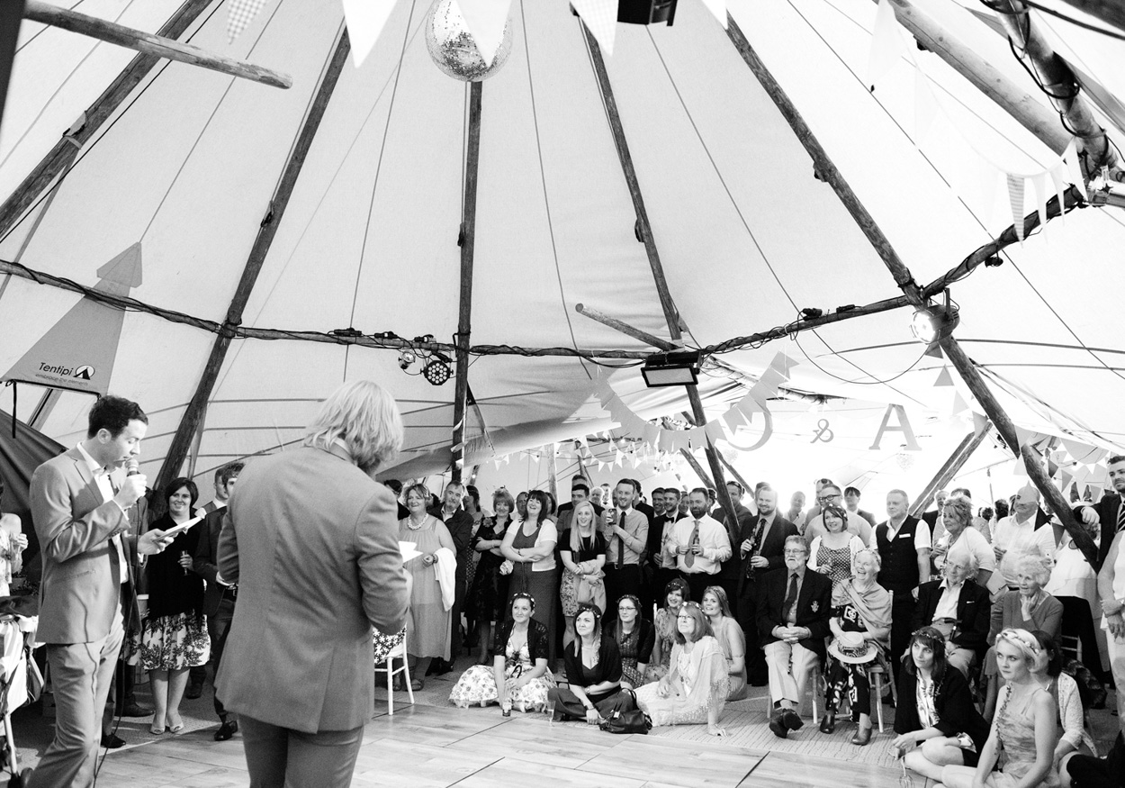 Excited wedding guests pose outside for a celebratory photo.