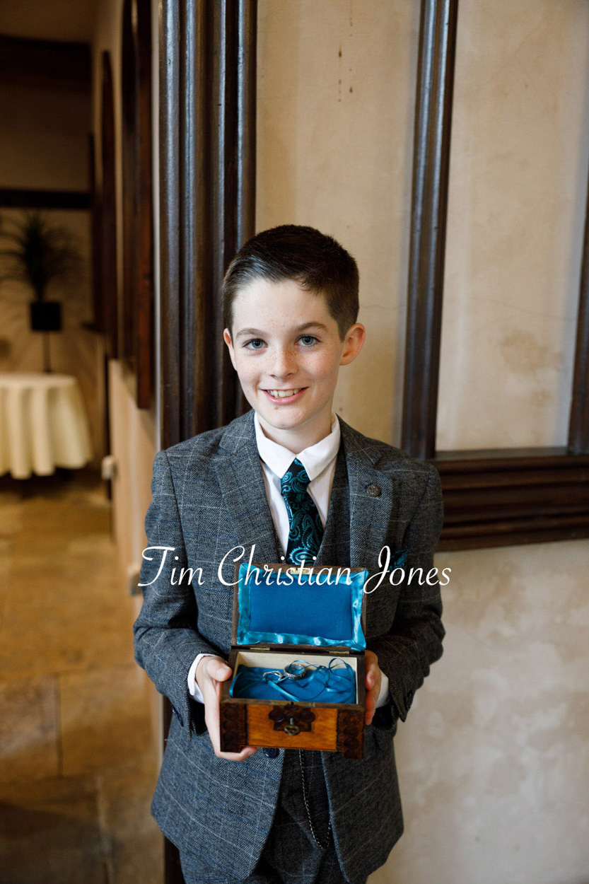 Ring bearer smiles proudly