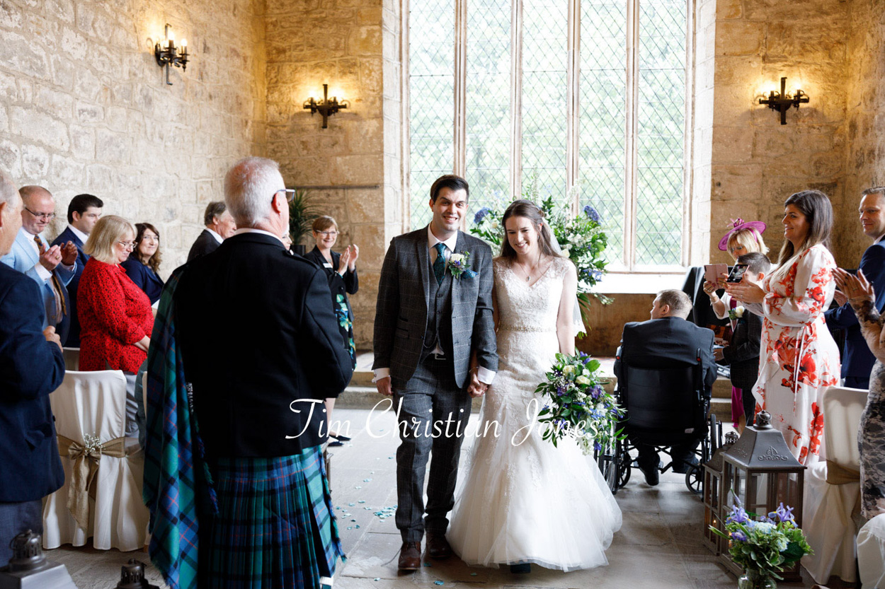 The couple walk down the aisle at this Priests House summer wedding