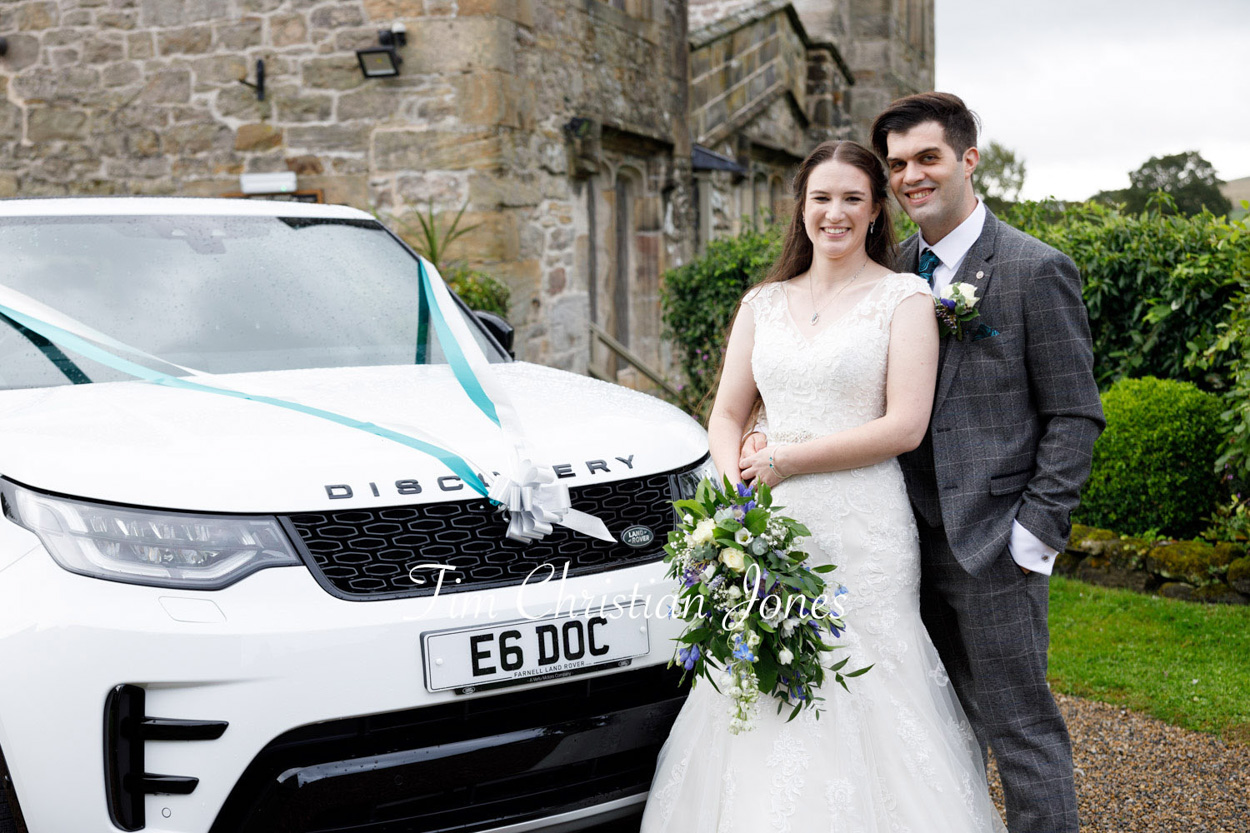The wedding car with blue and white ribbon detail - the couple naturally