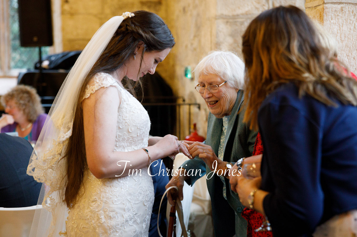 Grandma admires the bride's ring as she leaves the Priests House wedding story