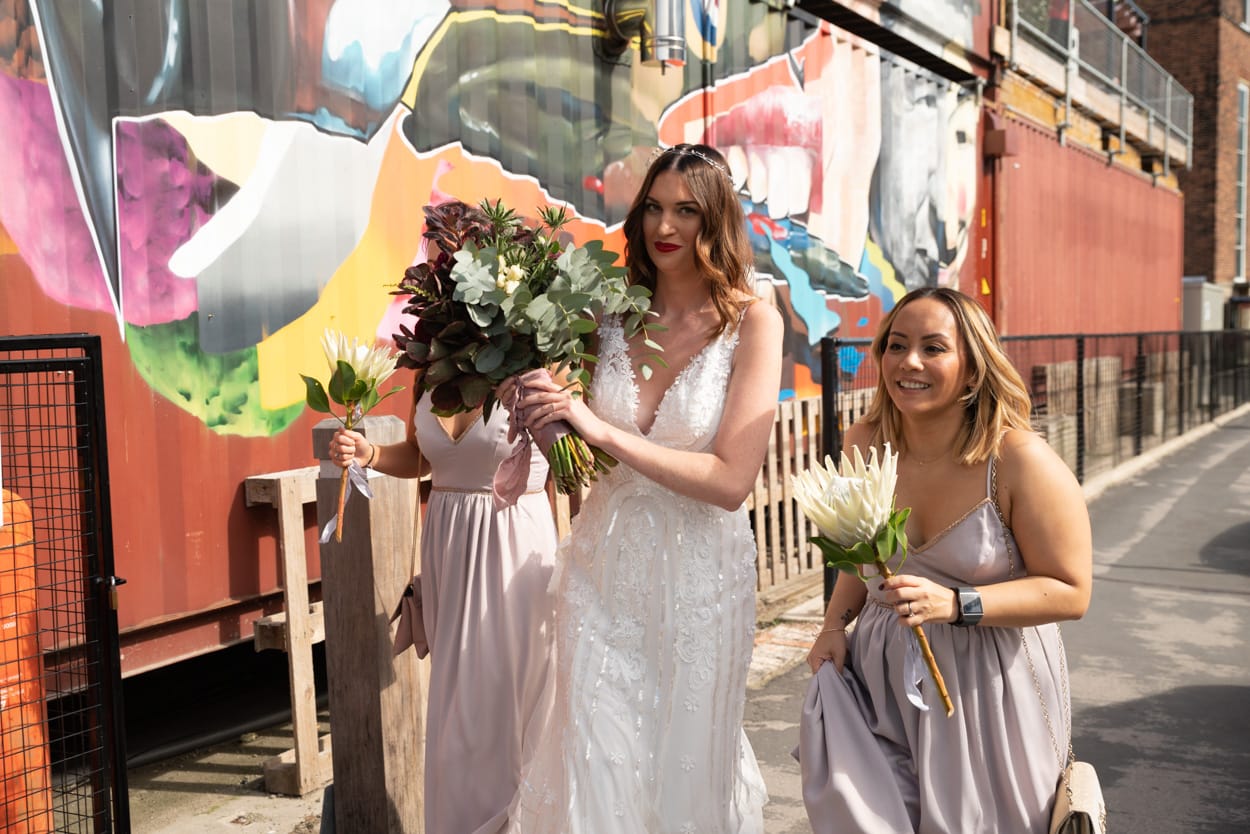 Bride and bridesmaids walking through York’s cobbled streets toward Merchant Adventurers’ Hall for the ceremony.