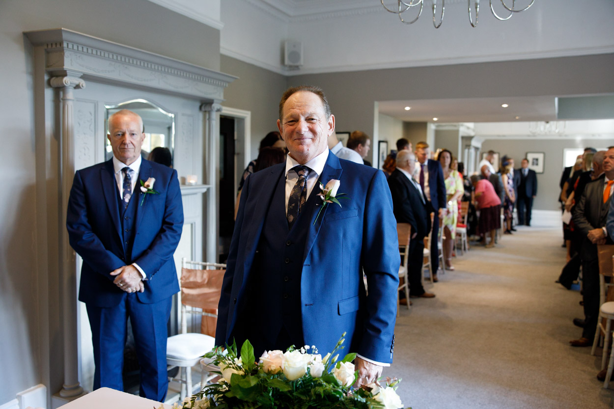 Groom smiles at the camera