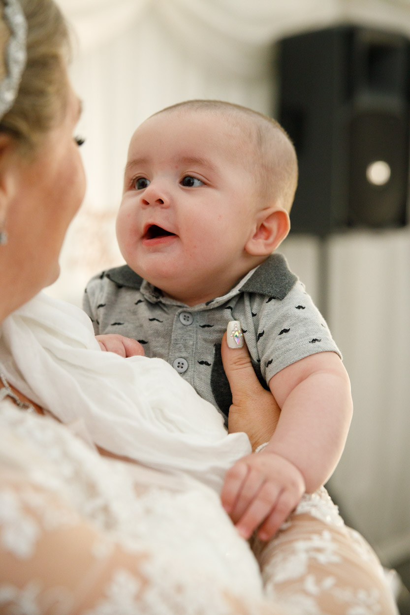 Bride holds a cute baby